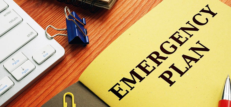 Booklet that reads Emergency Plan on desk