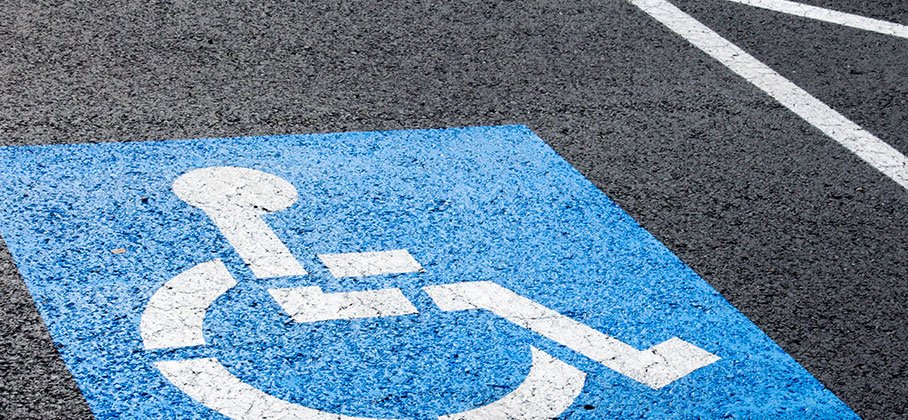 Pavement with wheelchair symbol painted on it