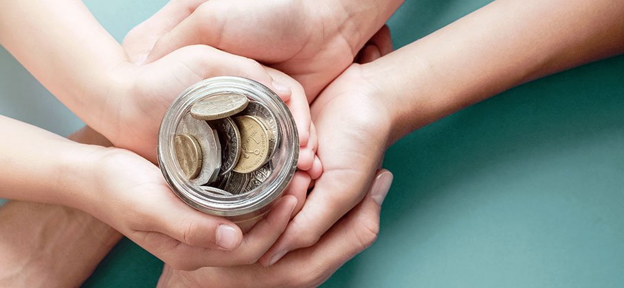 hands around a jar of money