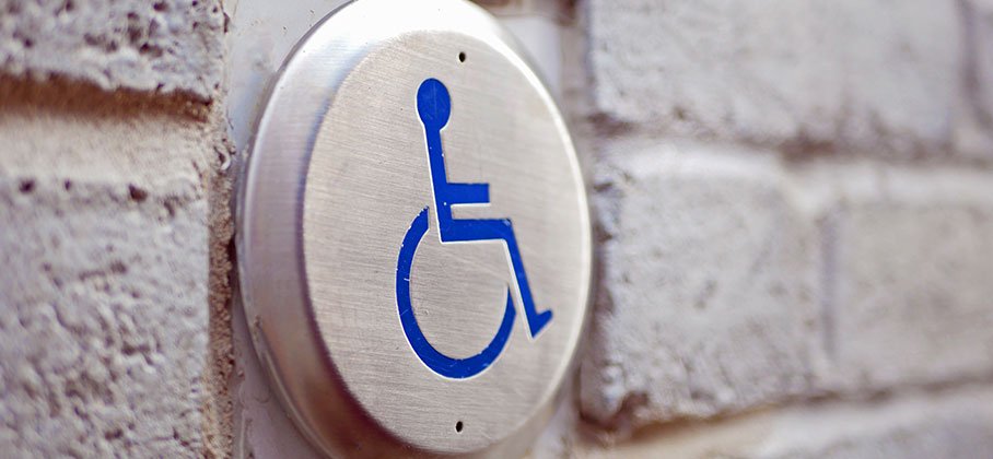 Wheelchair button on side of building
